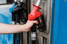 stock-photo-selective-focus-man-holding-red-gas-pump-gas-station